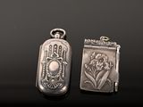 two silver lockes sitting on top of a table next to each other