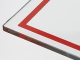 a close up of a piece of glass with a red border