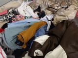 a suitcase full of clothes and clothes on the floor
