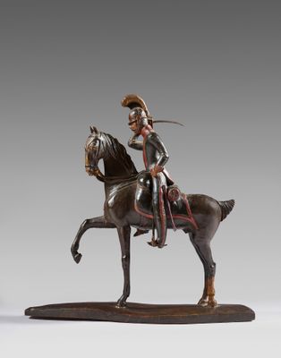 statue of a man riding a horse with a sword on its back