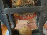 a clock that is sitting on a shelf in the room