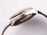 a close up of a watch with a rope around it