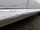 a close up of a car ' s door handle and the side of the car