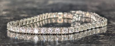 a close up of a diamond bracelet on a table