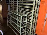 a room with a bunch of metal racks and orange lockers