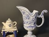 a small blue and white pitcher and a small blue and white teapot