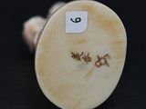 a close up of a small white object with writing on it