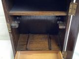 a small wooden cabinet with a drawer inside of it