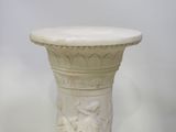 a white vase with a statue on top of it