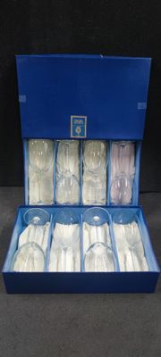 six empty glasses in a blue box on a table