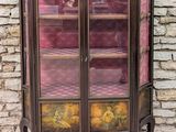 a small cabinet with a glass door on top of it