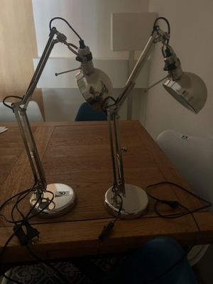 two lamps that are on top of a wooden table
