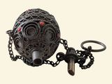 a metal ball with a chain around it and a key