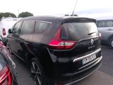 a black car parked in a parking lot with other cars