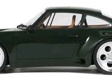 a green toy car that is sitting on a white surface