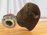 a broken wheel on a wooden table with a red string