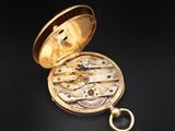 an antique pocket watch on a black background
