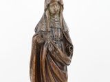 a wooden statue of a woman holding a baby