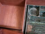a wooden box that has a drawer inside of it