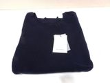 black t - shirt with a tag on it sitting on a white surface