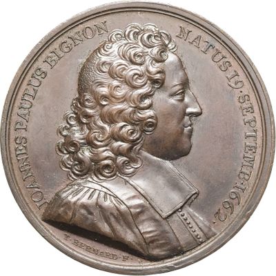 une vieille pièce d'argent sur laquelle figure le portrait d'un homme aux cheveux bouclés