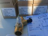 a box of waterflow valves on a table next to some boxes of water