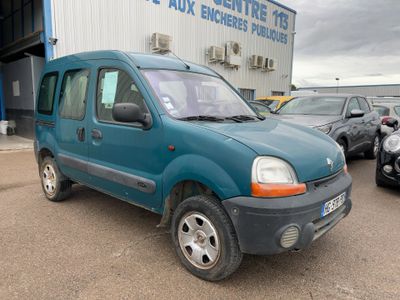 a small blue van parked in front of a building