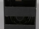 an old black amplifier sitting on top of a white table
