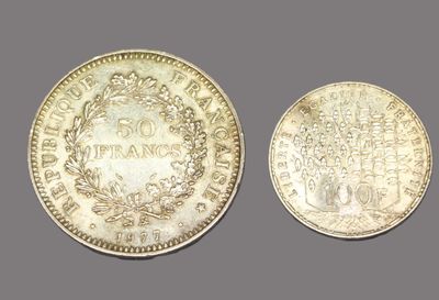 two silver coins, one with a crown and the other with a crown on it