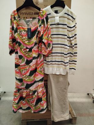 two women ' s dresses are on display in a clothing store