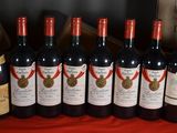 several bottles of wine are lined up on a table