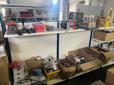 many boxes of electronic equipment on a shelf in a room
