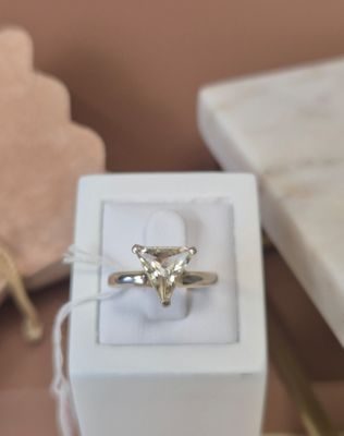 a white box with a ring inside of it on a table