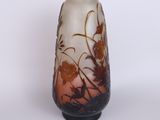 a vase with a floral design on it sitting on a table
