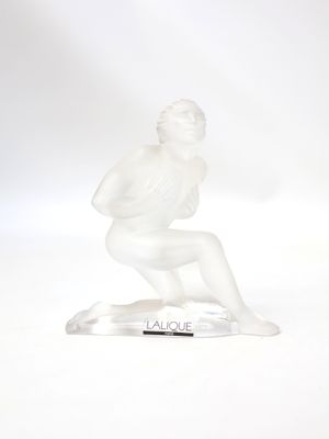 statue of a man kneeling on a base with a pen in his hand