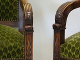 pair of green upholstered chairs with wood arms and arms