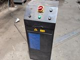 a black box with a red button on it in a garage