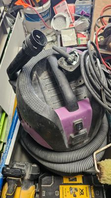a pile of assorted items and tools on a table