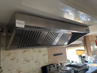a stainless steel hood above a stove in a kitchen