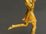 statue of a woman holding a tennis racquet on a marble base