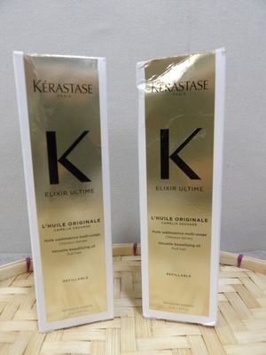 two bottles of kerastasee hair care sitting on top of a basket
