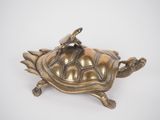 brass figurine of a turtle with a umbrella on its back