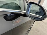 a side view mirror of a car with a sticker on it