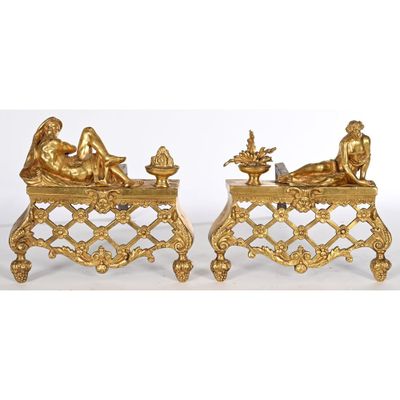 pair of antique gold figurines of a man and a woman sitting on a bench