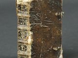 an old book sitting on top of a table with writing on it