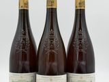 three bottles of wine sitting next to each other on a white surface