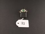 a close up of a ring on a table with a price tag