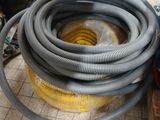 a pile of hoses sitting on a floor next to a pile of other equipment