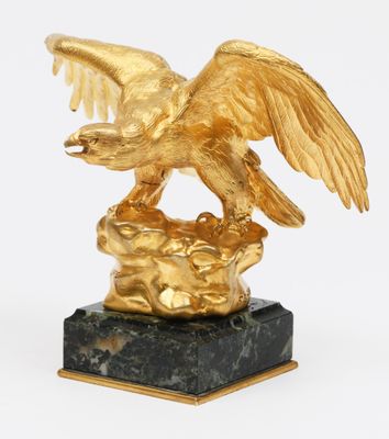 an image of a gold eagle statue on a black marble base