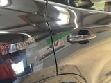 a close up of a car ' s door handle with a sticker on it